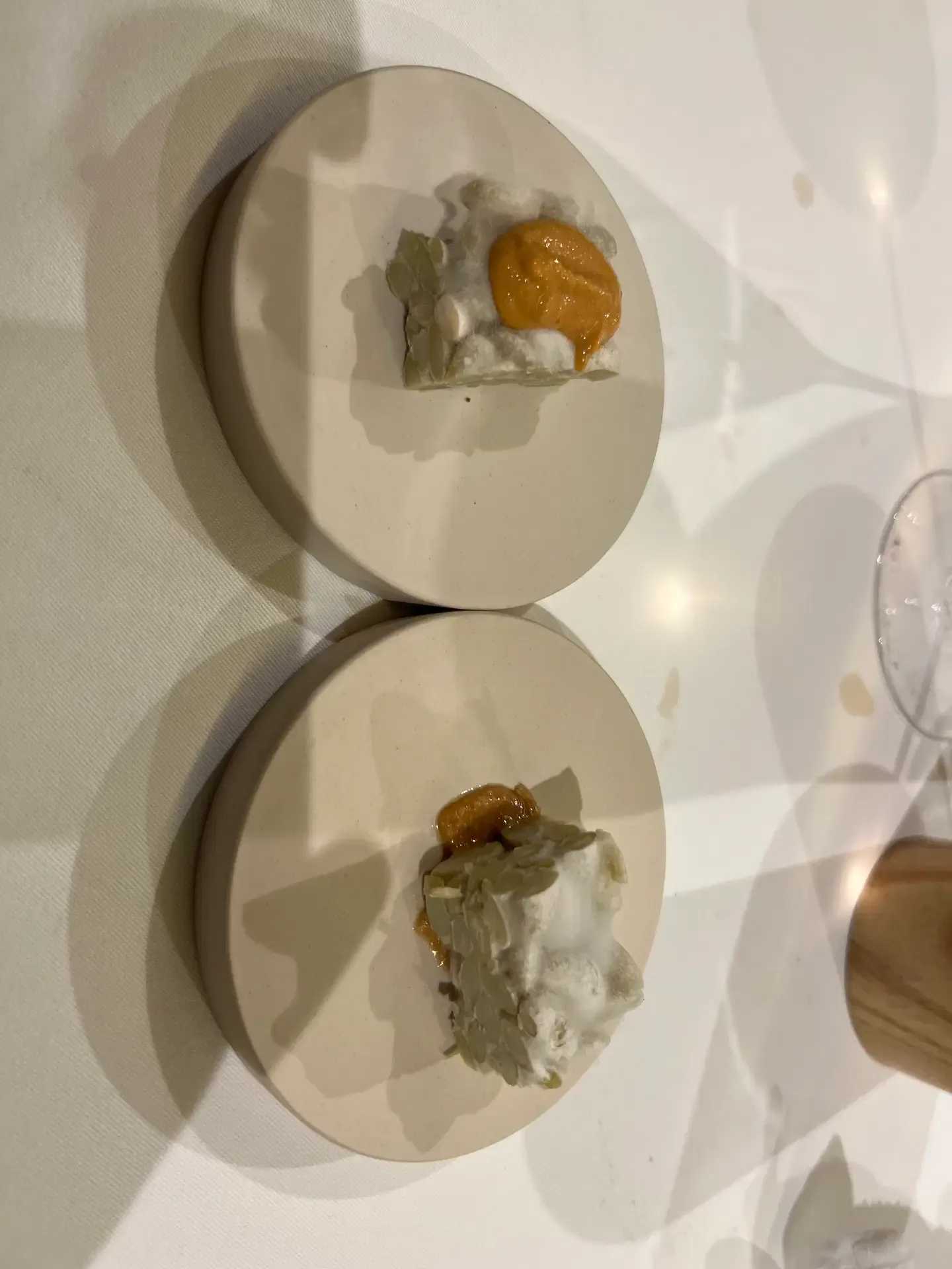 A clear broth with delicate blossoms and a green rosette at Mugaritz